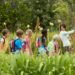 Young teacher with children on nature field trip