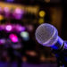 Microphone set up with lights for a comedy music show in a bar.