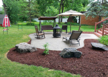 Man mulching yard in suburban house