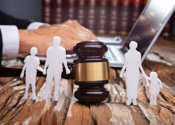 Separation Of Family Silhouette With Gavel In Courtroom